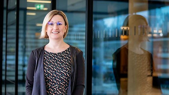 Portrait of Kerstin, reflected in the window pane of a scientific institute