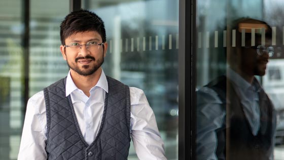 Meet Bhatt Portrait of Meet, reflected in the window pane of a scientific institute